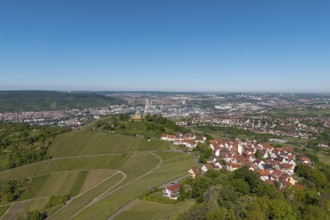 Urban landscape with vineyards, red roofs and fields under a blue sky, view of Rotenberg near