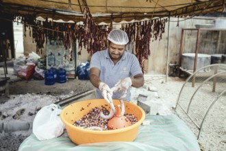 Traditional camel restaurant in Salalah, stuffing camel sausages, Dhofar, Oman