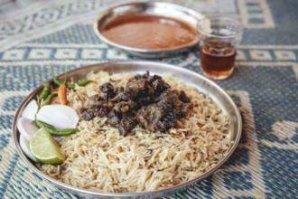 Traditional camel restaurant in Salalah, dry braised camel meat on rice, Dhofar, Oman