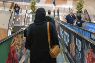 Veiled woman with handbag, Abu Dhabi, United Arab Emirates