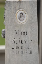 Old gravestone with inscription and an oval photo portrait, Zgornje Jezersko, Gorenjska, Slovenia