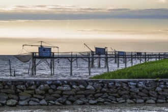 Sunset over Fishing huts over Gironde Estuary, Braud-et-Saint-Louis, France
