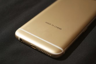Back of golden smartphone with text Made in China. Concept of globalization and offshore