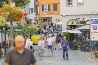Cosy old town atmosphere with people strolling through a lively alley, 950 years of Weil der Stadt