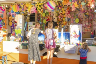 Children and adults play at a colourful stand at a fair, 950 years Weil der Stadt ceremony,