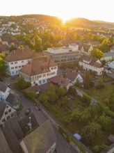 Idyllic view of a village at sunset with historic buildings and lush greenery, 950 years Weil der