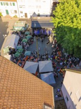Aerial view of a large event with many people, tents and an outdoor stage, 950 years Weil der Stadt