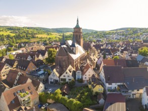 Aerial view of a village with a central church and surrounding half-timbered houses, 950th