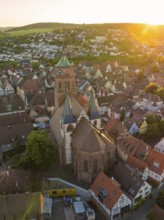 Aerial view of a church and old town centre in the evening light with surrounding landscape, 950