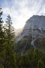 Mountain landscape in autumn, sun star in the morning light, rocky mountain peak of the