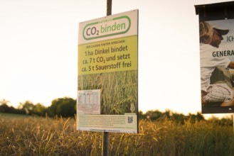 Sign on a field at sunset emphasises CO2 sequestration and sustainability