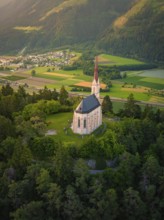 Sublime church on a hill overlooking a valley in the warm evening light