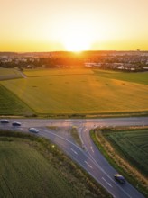 Crossroads and fields at sunset, cars on the road, peaceful atmosphere, Renningen, Germany
