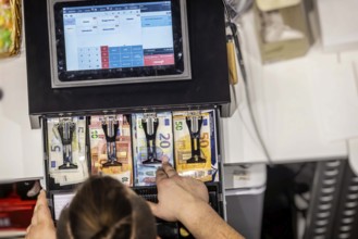 Restaurant cash register. Cash register with display and banknotes in the catering trade.