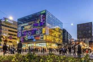 Stuttgart Art Museum in the evening with light installation and people on the steps. Long Night of