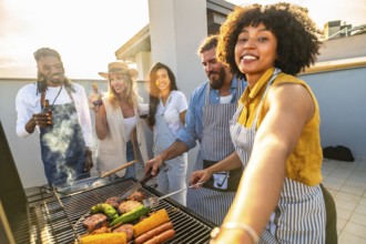 Cheerful friends grilling delicious meat and fresh vegetables while capturing selfies at a vibrant