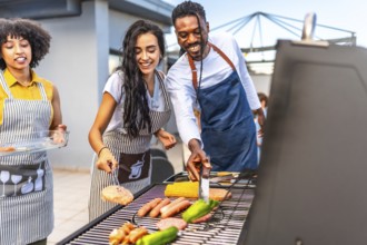 Happy friends enjoying a rooftop barbecue party, grilling delicious food, sipping drinks, and