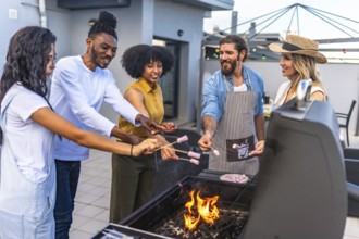 Happy friends enjoying a rooftop barbecue, roasting marshmallows over glowing flames while sharing