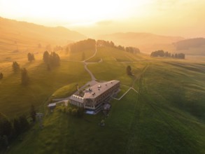 Architectural building on a hill with evening light and peaceful atmosphere, Alpe di Siusi,