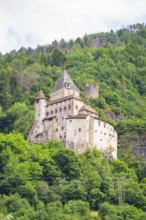 Medieval castle on a wooded hill with towers and walls, Dolomites, South Tyrol, Italy