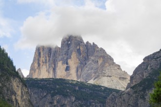 Majestic Dolomites covered by clouds under a blue cloudy sky, Dolomites, South Tyrol, Italy