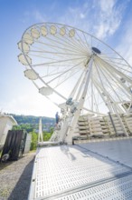 View of a large Ferris wheel under a blue sky, modern construction, construction of Ferris wheel,