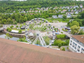 Ferris wheel with a view of a country town, river and green areas in summer weather, Ferris wheel