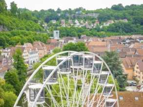 Ferris wheel towers over the rooftops and offers views of the surrounding hills, Ferris wheel