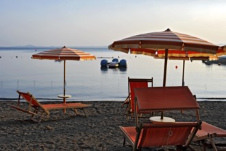Beach, deckchairs, sunshades at the lido, Lake Bolsena, Lago di Bolsena, volcanic crater lake, calm