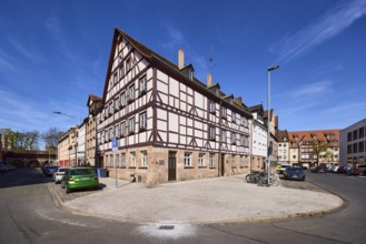 Old town, half-timbered house, general architecture, lantern, parking lane with vehicles, blue sky,