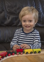JBlond boy, 2 years old, playing with toy train in Ystad, Skåne County, Sweden, Scandinavia
