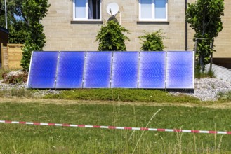 Solar collector in the garden of a detached house. Nagold, Baden-Württemberg, Germany
