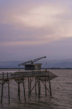 Sunset over Fishing huts over Gironde Estuary, Braud-et-Saint-Louis, France