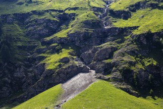 Waterfall and green slopes in a rock face, Zinal valley, Val d'Anniviers, Valais Alps, Canton