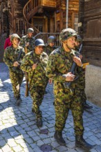 Soldiers from the local heritage society accompany the Corpus Christi procession, historic town