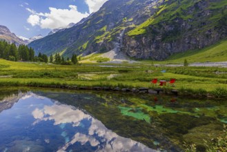 Mountains and clouds reflected in a pond, near Relais Tzoucdana, Zinal, Val d'Anniviers, Valais