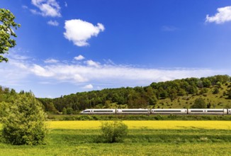 InterCityExpress ICE en route on the Swabian Alb near Lonsee. Landscape on the railway's