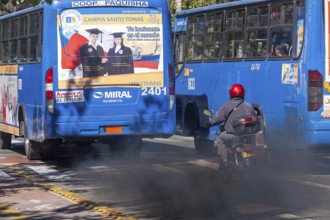 Buses in motion emitting pollution, City of Quito. Pichincha province, Ecuador, South America