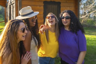Four multi ethnic female friends enjoying a day together, laughing and having fun outdoors
