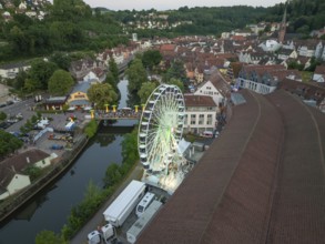 Bird's eye view of urban landscape with Ferris wheel and river, 950 years of Calw, Germany