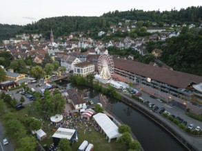 Urban festival with Ferris wheel and event tents next to a river, 950 years of Calw, Germany