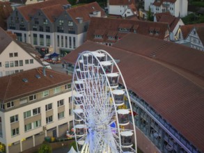 A Ferris wheel towers over the roofs of a town at night, 950 years of Calw, Germany