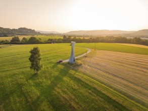 Extensive landscape with a viewing tower under a clear sky in a summery atmosphere