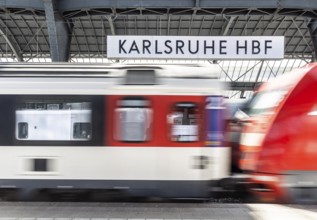 Karlsruhe main station with station sign and SBB InterCity. Karlsruhe, Baden-Württemberg, Germany
