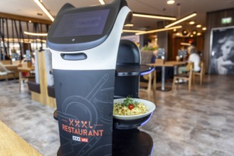 Furniture store XXXLutz Mann Mobilia Karlsruhe. In the restaurant, serving robot Lutzi supports the