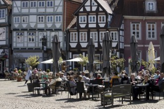 People in the outdoor catering area in the old town with many half-timbered houses, Großer Plan,