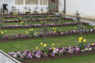 Colourfully planted row graves in the cemetery of the Neustift St Margarethen monastery, Vahrn,