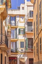 Residential building with balconies at the flats in a narrow alley in the old town at Palma de
