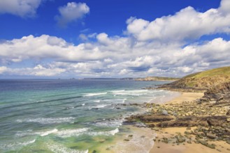 Rocky coastline with breaking waves on the shore and a scenics view to the horizon a sunny summer