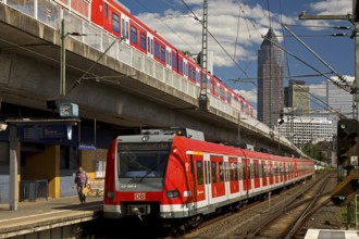 Two regional express trains on different levels at Frankfurt West station with Messeturm, Frankfurt